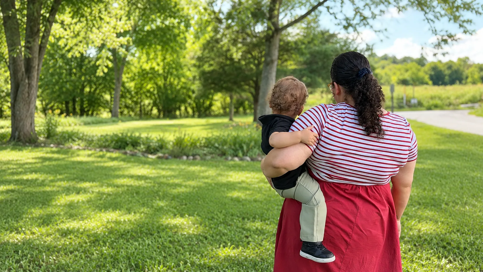 Abigail carrying Oliver outdoors