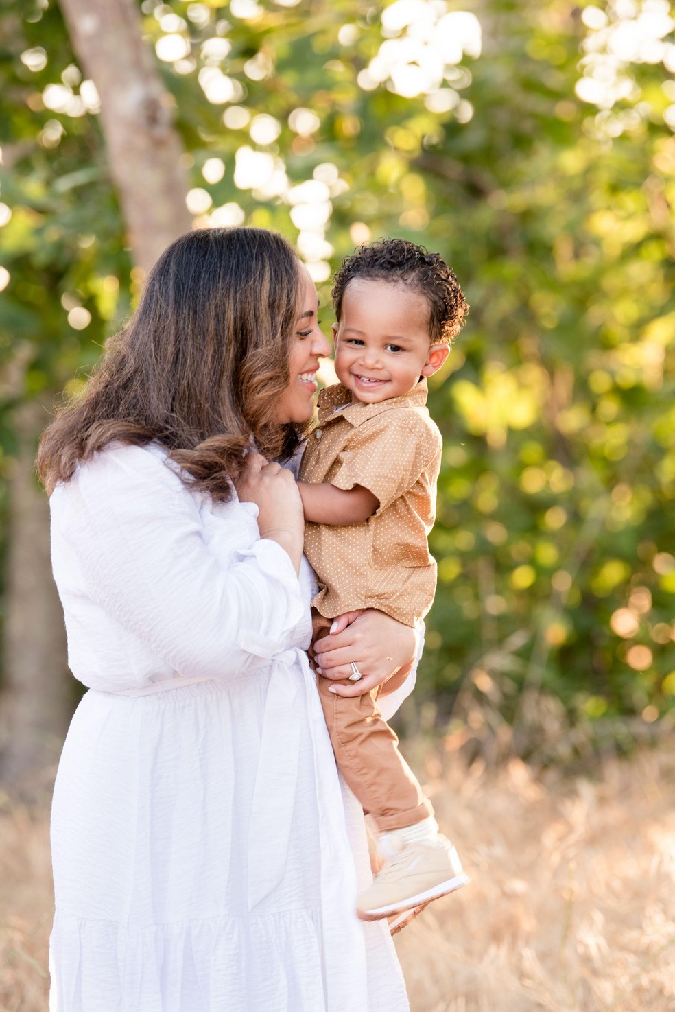 Mother holding her young son outdoors